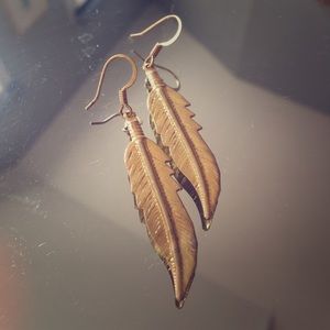 Gold coloured feather earrings